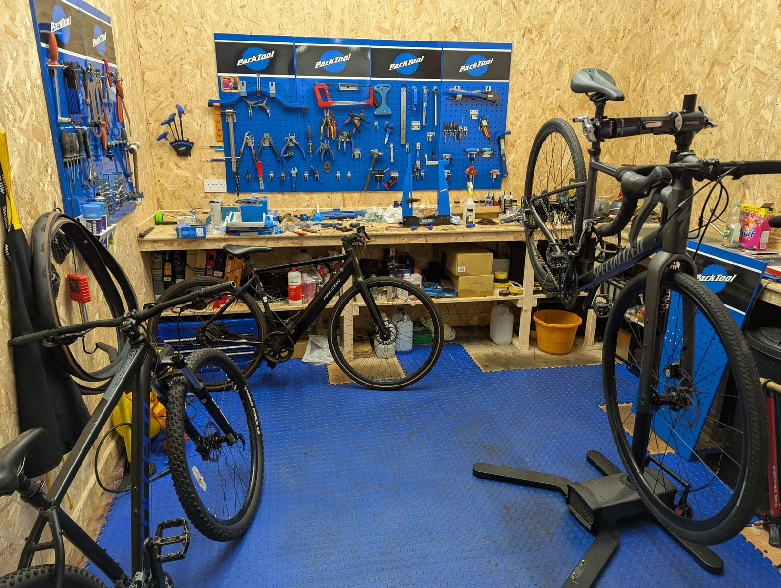 EAT Cycling workshop interior in Largs showing the shop wall display, cycling brands, and parts area.